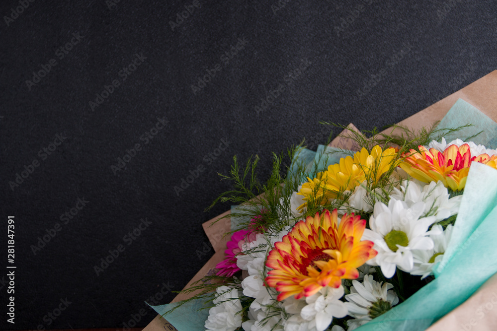 Fototapeta premium bouquet of gerberas on a black background copy space white orange pink yellow