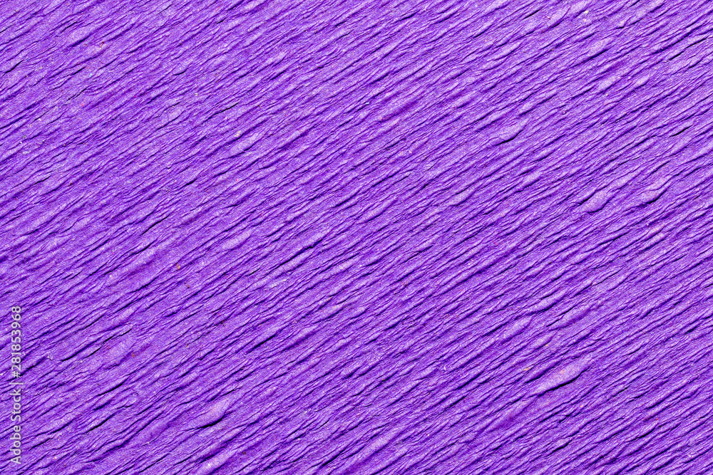 Abstract textured background of the close up detail of a sheet of purple crepe paper Abstract textured background of the close up detail of a sheet of purple crepe paper