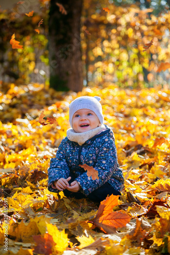 laughing baby girl in the autumn park