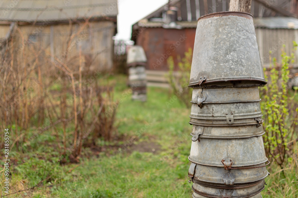 Country landscape. Pyramids of old metal buckets placed on each other in the garden. Country landscape. Pyramids of old metal buckets placed on each other in the garden.