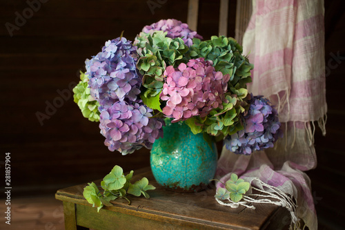 Fototapeta Naklejka Na Ścianę i Meble -  Bouquet of hydrangea flowers in a vase on a chair