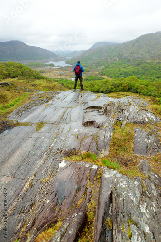 Hiker admiring the beauty of Killarney National Park at Lady's View viewpoint. One of most impressive overlooks on the Ring of Kerry, Ireland.