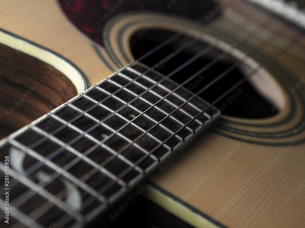 Fototapeta premium six - string acoustic guitar on a black background. low key. music day