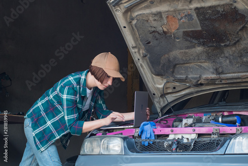 Female mechanic fixing car in a garage