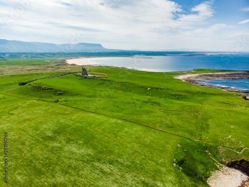 Spectacular aerial view of Mullaghmore Head with huge waves rolling ashore. Picturesque scenery with magnificent Classiebawn Castle.