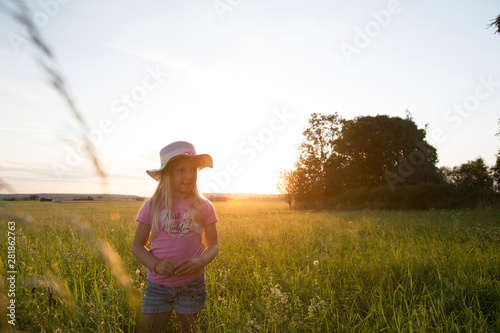 Happy girl enjoying the sunset at the countryside © mmphoto