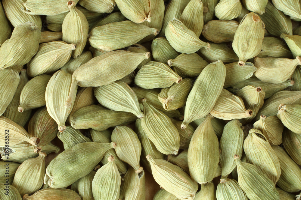Top view on a pile of dry scattered unrefined cardamom seeds Top view on a pile of dry scattered unrefined cardamom seeds
