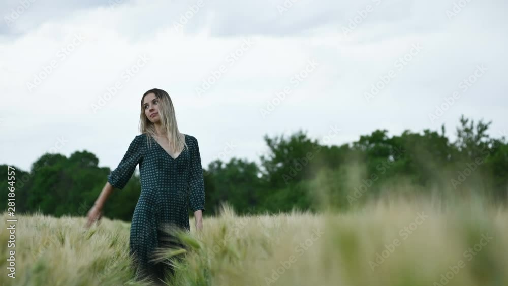 Portrait of a happy attractive Caucasian blonde with wet hair walking in the rain on nature. Outdoor field of wheat. Happiness hope flirting and coquetry Portrait of a happy attractive Caucasian blonde with wet hair walking in the rain on nature. Outdoor field of wheat. Happiness hope flirting and coquetry