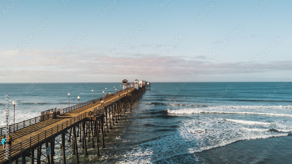 OCEANSIDE, California (USA): Drone shot of the longest wooden maiden pier of the USA West Coast, Oceanside Pier. OCEANSIDE, California (USA): Drone shot of the longest wooden maiden pier of the USA West Coast, Oceanside Pier.