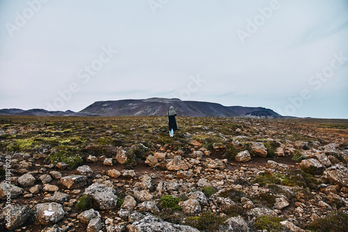 Young girl takes pictures of icelandic landscapes