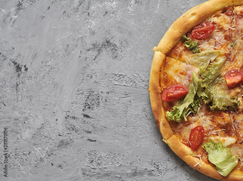 Delicious pizza on grey stone background.