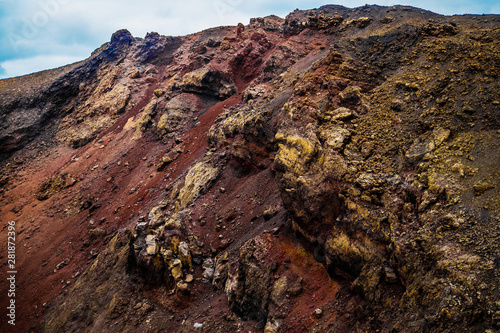 incredibly beautiful volcanoc landscape with black sand and red mountains and a beautiful sky during the day on the spanish island of Canary Lanzarote photo