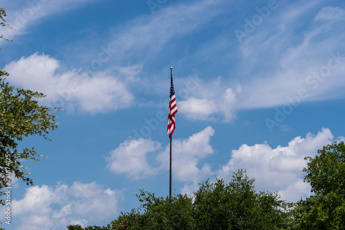 US Flag hangng down on a calm, windless day. photo