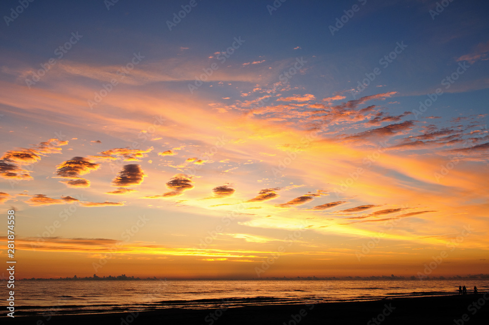 Beautiful orange sunset over the sea on the blue sky