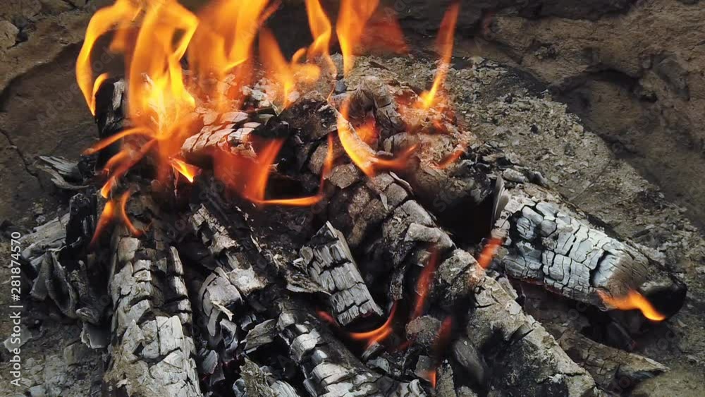 Close view at glowing charcoal and flame in barbecue grill Close view at glowing charcoal and flame in barbecue grill