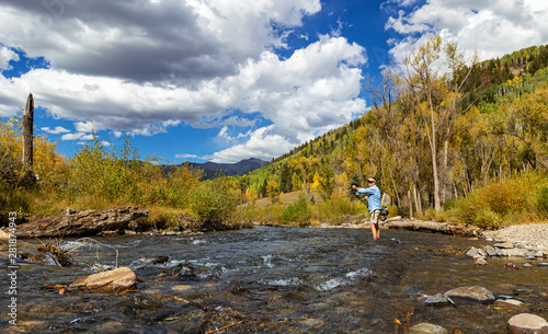 Fly Fisherman in action on Rocky Mountain stream Near Telluride, CO, photo