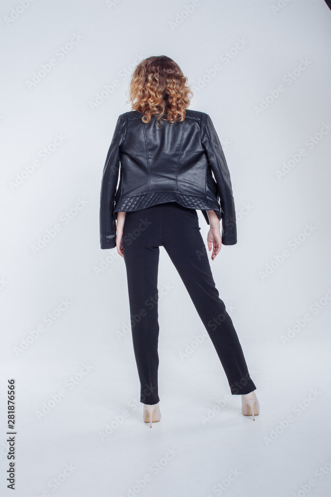 Pretty young fashion sensual woman posing on white background with dressed in hipster style leather jacket outfit. Stylish fashionable girl hipster in black clothes and white shirt. Pretty young fashion sensual woman posing on white background with dressed in hipster style leather jacket outfit. Stylish fashionable girl hipster in black clothes and white shirt.