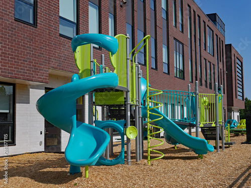 Photography large brick school building with playground equipment