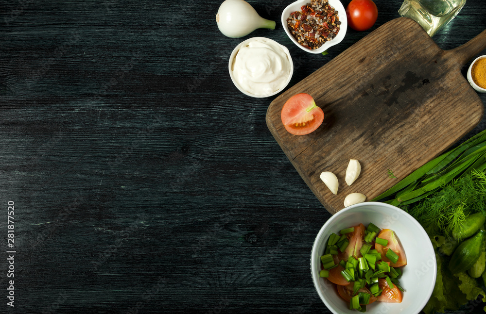 Salad with vegetables. View from above. Fresh salad in a plate on a dark background. Garlic, tomato, cucumber, dill and onion in a dish of dark surface. Copy space. Salad with vegetables. View from above. Fresh salad in a plate on a dark background. Garlic, tomato, cucumber, dill and onion in a dish of dark surface. Copy space.