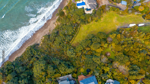 Aerial View from the Beach, Green Trees   and Cliff of Orewa in New Zealand - Auckland Area photo