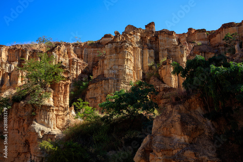 Earth Forest of Yuanmou in Yunnan Province, China - Exotic earth and sandstone formations glowing in the sunlight. Naturally formed pillars of rock and clay with unique erosion patterns. China Travel