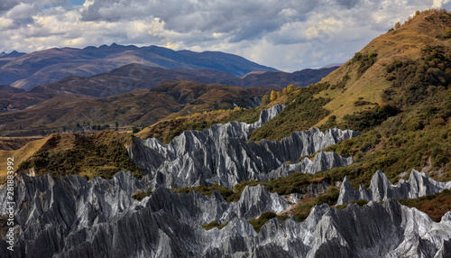 Bamei stone forest, exotic pillars of gray stone situated in the grasslands of Sichuan Province, China. Unique rock formations with clouds in the distant background. Martian Tibetan Landscape photo