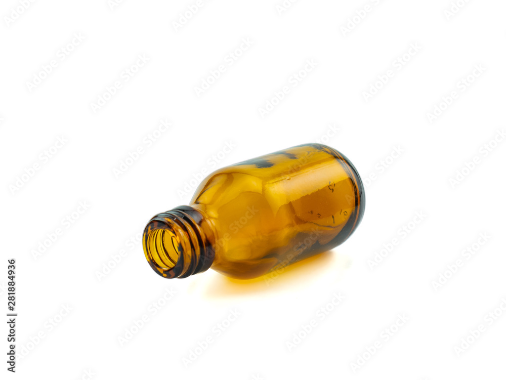 Small pharmaceutical amber empty lying glass bottle without lid for aromatherapy or mock-up on white background