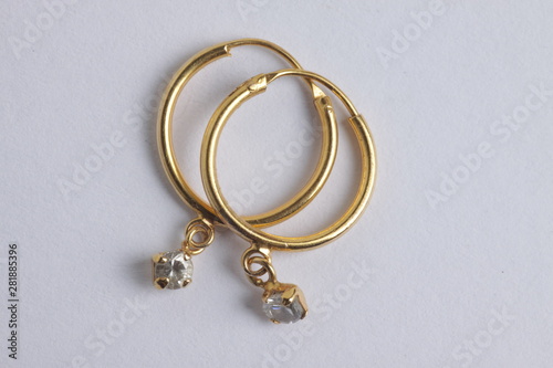 close up shot of gold ear ring on a white isolated background