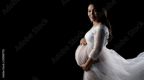 Beautiful Asian pregnant women on black background