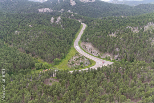 aerial view of a highway through a forest