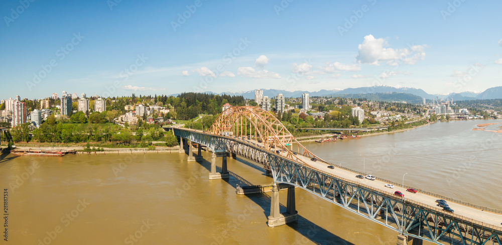 Aerial panoramic view of Pattullo Bridge over the Fraser River. Taken in Surrey, Greater Vancouver, British Columbia, Canada.