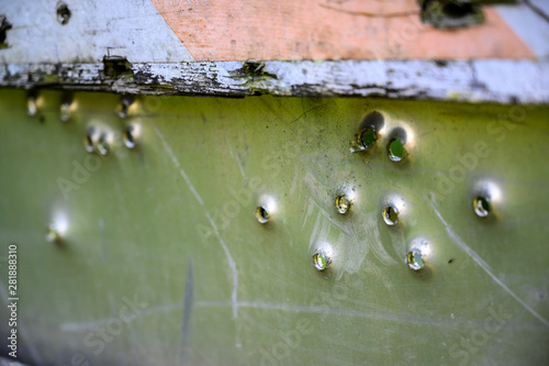 Back view of buckshot damage to a steel road sign 
