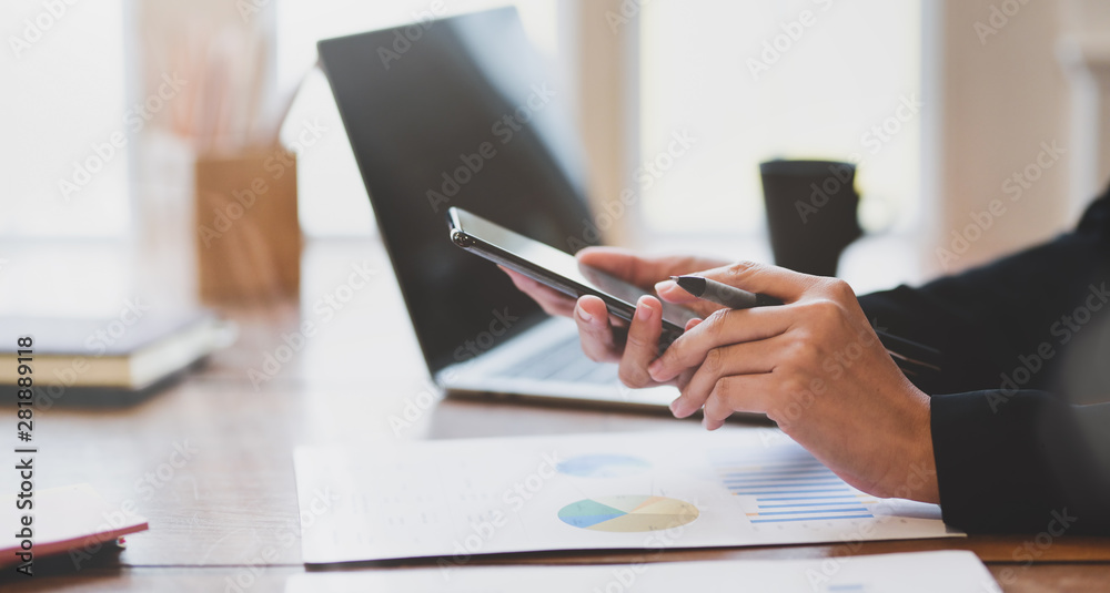 Close-up view of businesswoman's hands holding smartphone