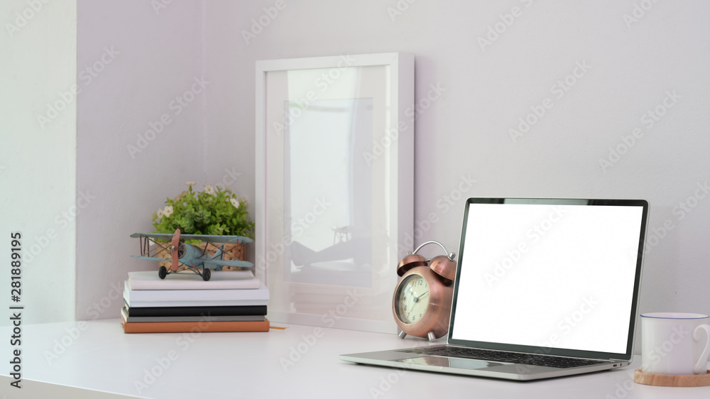Modern workplace with blank screen laptop with office supplies Modern workplace with blank screen laptop with office supplies