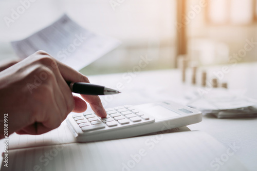 Tableau sur toile Man use calculators and documents that calculate expenses in the home office