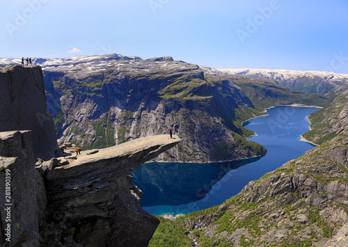 Scenic view of Trolltunga (the famous Troll's tongue Norwegian destination) and Ringedalsvatnet Lake in Odda with hiker standing of the rock, Norway