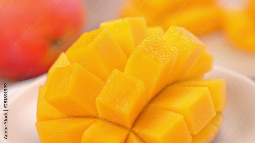 Beautiful fresh chopped mango, showing on a rotating white plate, close up, 4K video shot. Beautiful fresh chopped mango, showing on a rotating white plate, close up, 4K video shot.
