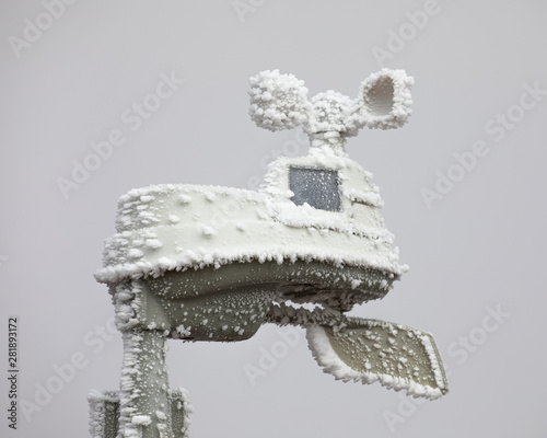 A weather station frozen in ice on a cold dreary day. 