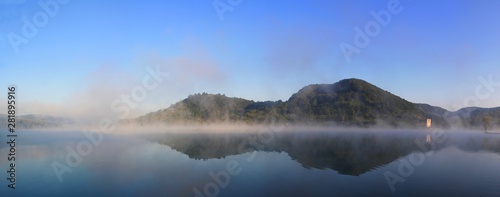 panoramic landscape with fog on the lake in the morning