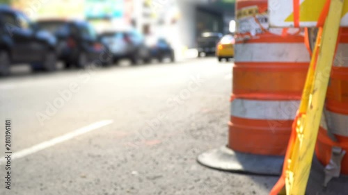 Wallpaper Mural New York City Streets defocused behind orange roadwork cones and warning sign, yellow taxi cab and bike commuters in the background Torontodigital.ca