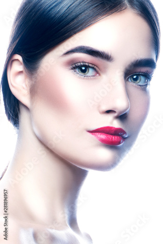 Closeup beauty face of young woman wearing salon makeup. Bright make-up, brunette hair, clean skin. Skincare facial treatment concept. White background. Isolated