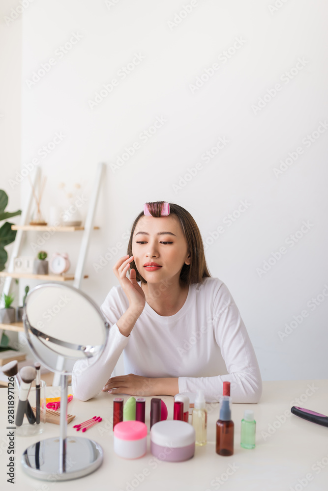 young beautiful woman applying her make-up young beautiful woman applying her make-up