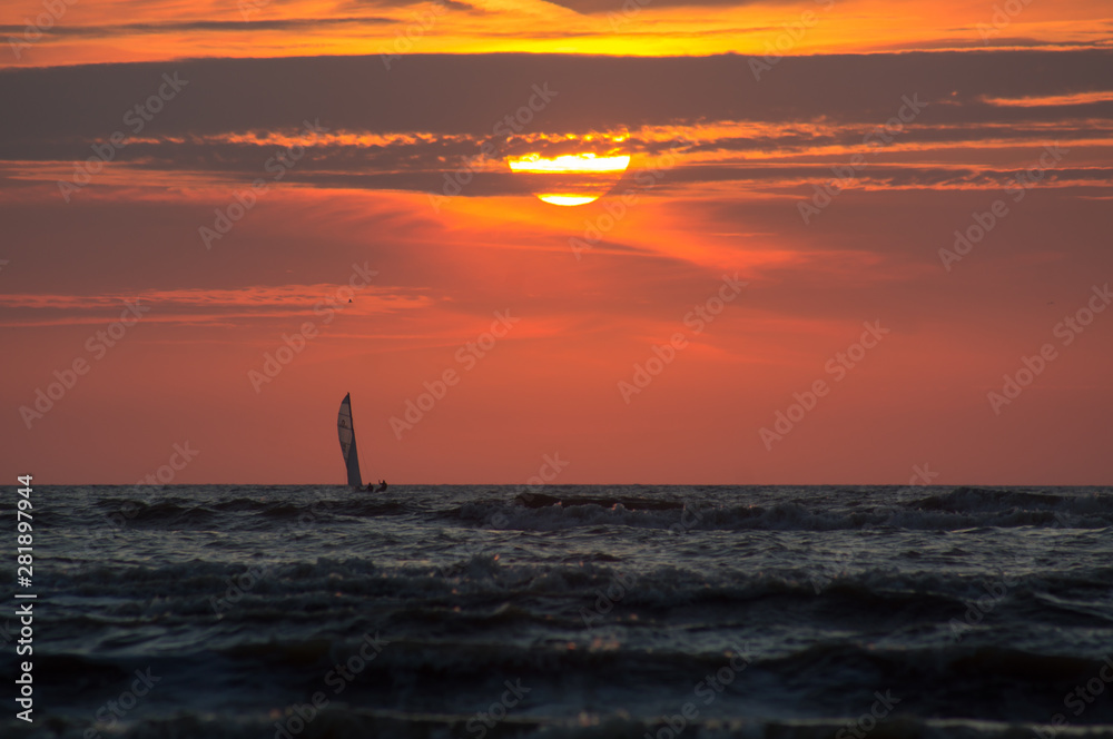Silhouette of a sailboat at Sunset Time.