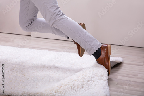 Man Stumble In A Carpet Near Ladder photo