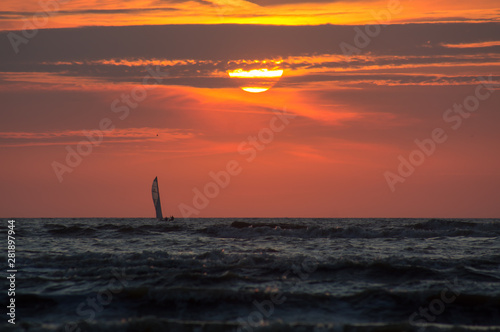 Silhouette of a sailboat at Sunset Time. © Ralph