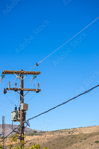 Power line voltage tower against blue sky