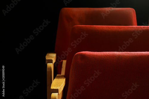 Empty red velvet seats for spectators in the theater or cinema