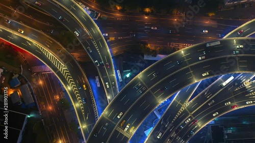 Cars and big vehicles moving in neon lighted Nanpu bridge in Shanghai at night an aerial view, 4K clip