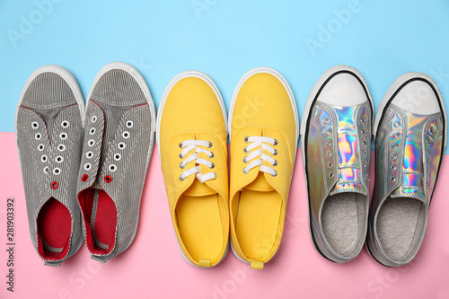 Modern trendy sneakers on color background, top view