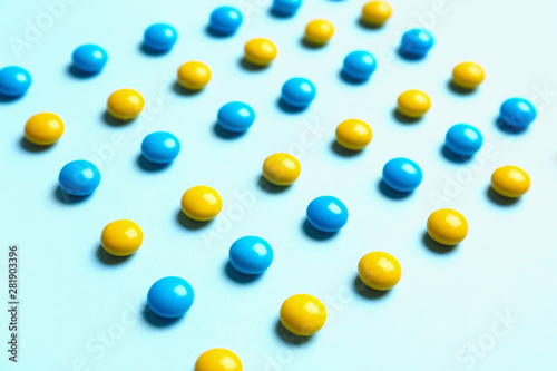 Delicious bright candies on light blue background